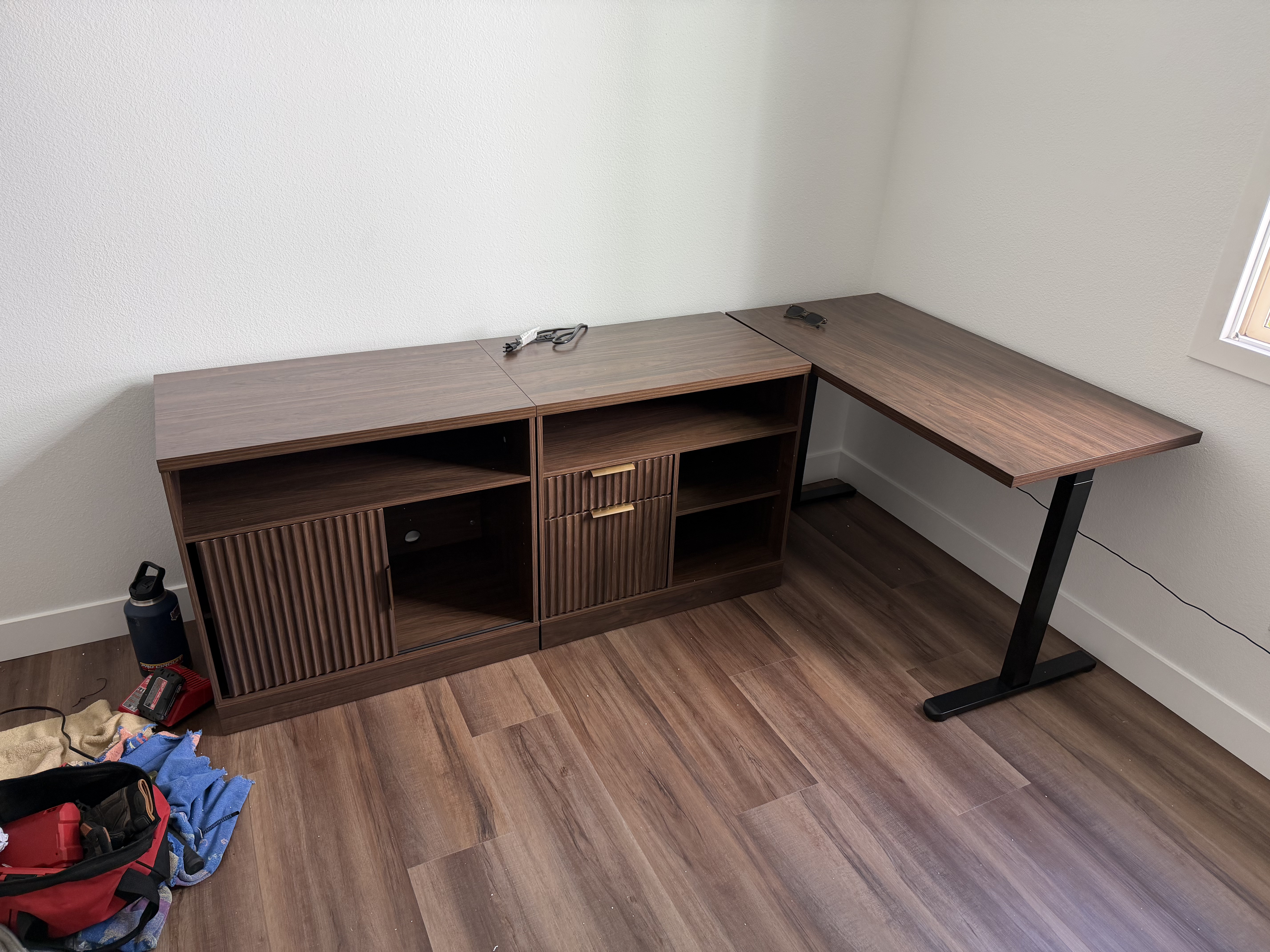 Completed office furniture assembly — standing desk and credenza