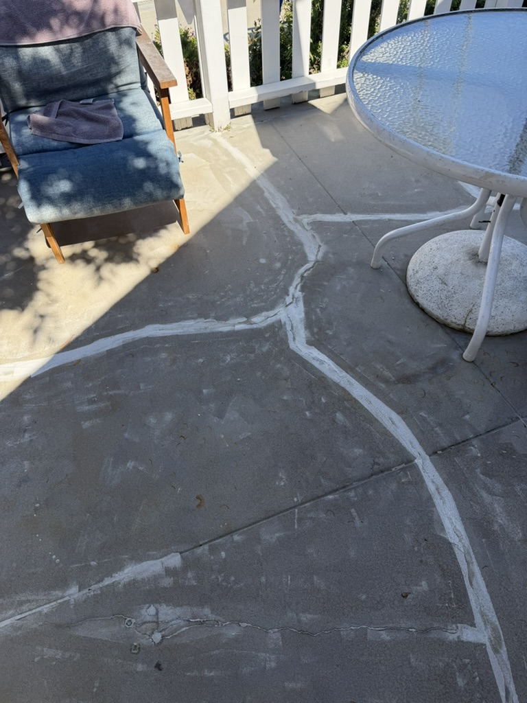 Cracked patio concrete marked out before grinding repair