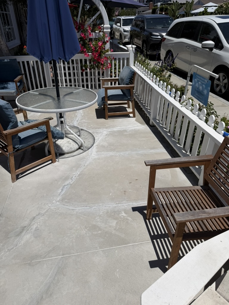 Finished patio concrete repair with seating and street view