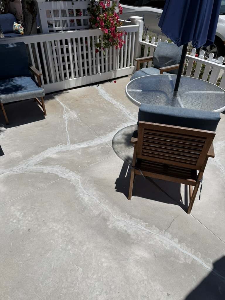 Completed patio concrete repair with furniture and umbrella set up
